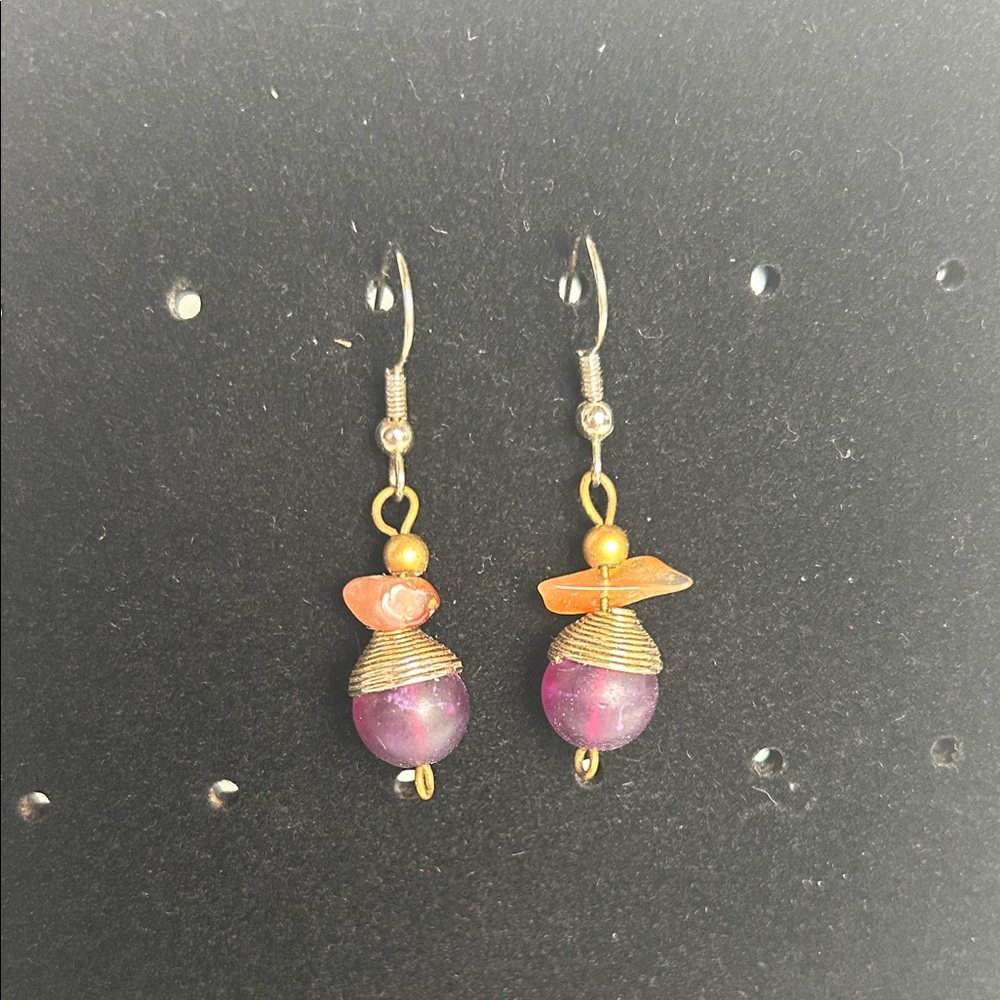 Silver tone hooks & gold tone metal  accents. Purple and orangey beads. Pierced